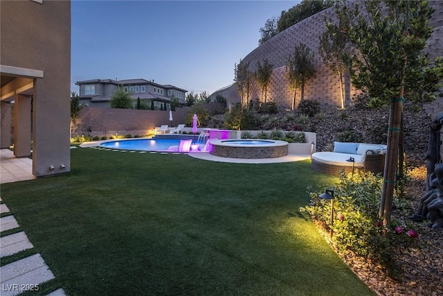 pool at dusk with a lawn, a patio area, and an in ground hot tub