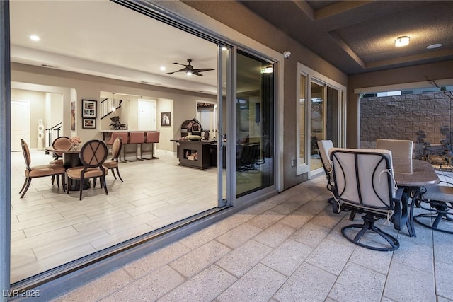 sunroom featuring ceiling fan