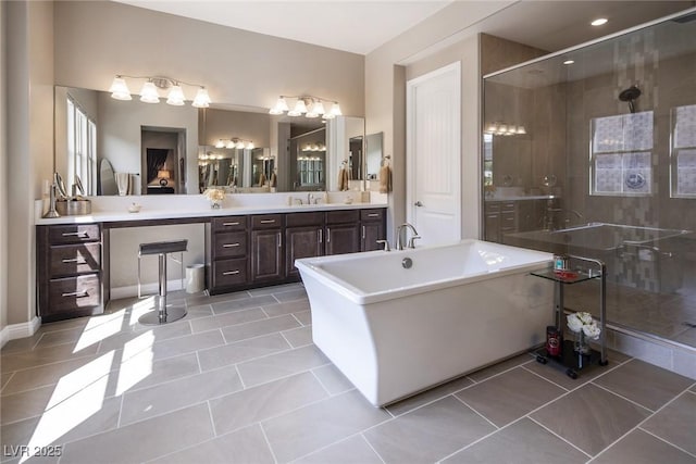 bathroom with tile patterned floors, vanity, and independent shower and bath