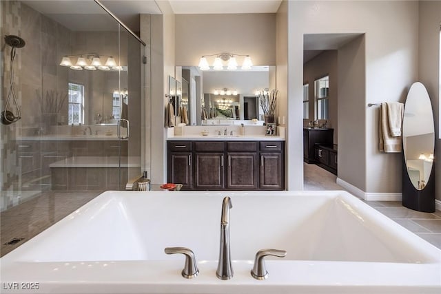 bathroom with vanity and shower with separate bathtub