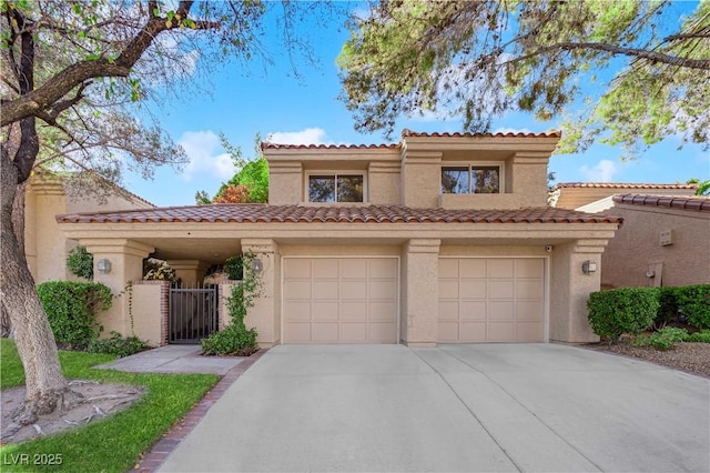 mediterranean / spanish-style house with a garage