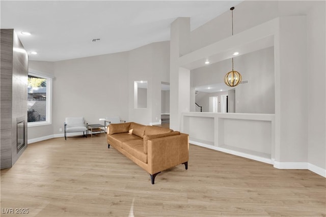 living room with light hardwood / wood-style floors and a chandelier