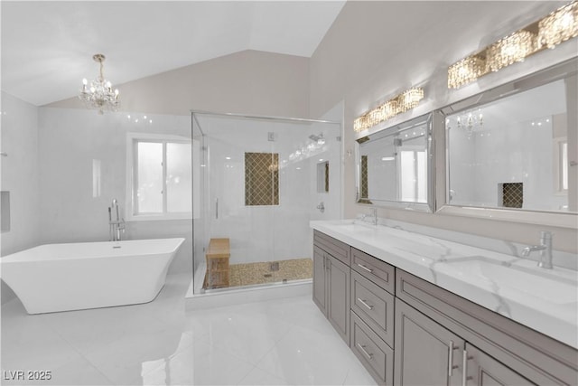 bathroom featuring a chandelier, separate shower and tub, vanity, and vaulted ceiling