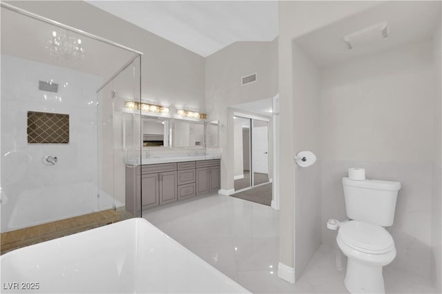 bathroom featuring vanity, lofted ceiling, toilet, tiled shower, and a notable chandelier