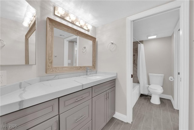 full bathroom featuring shower / tub combo, vanity, and toilet