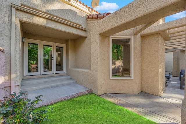 entrance to property with french doors and a patio