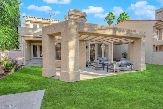 rear view of property with a lawn, outdoor lounge area, french doors, and a patio