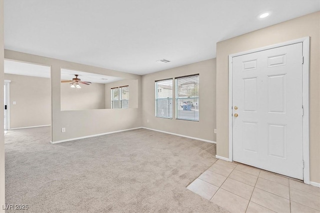 carpeted foyer featuring ceiling fan