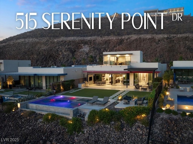 exterior space featuring an in ground hot tub, a patio, and an outdoor living space