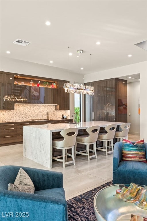 living room featuring light tile patterned floors and sink