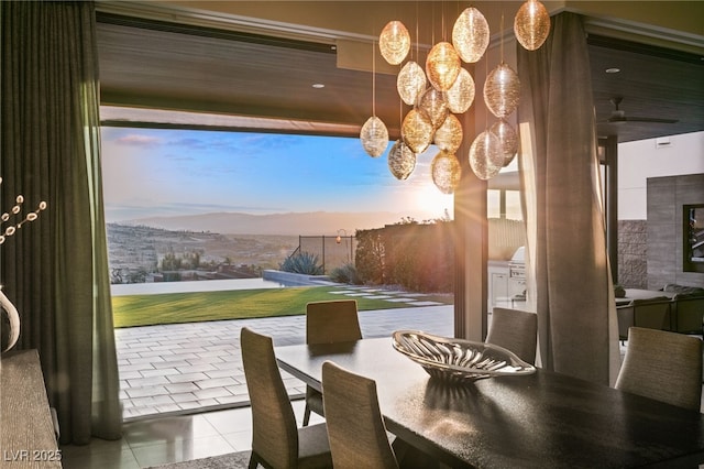 dining area with a mountain view and light tile patterned floors