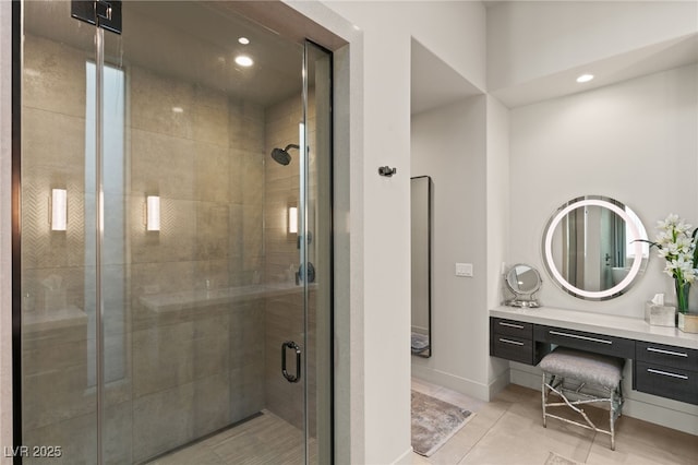 bathroom featuring tile patterned flooring, vanity, and a shower with door