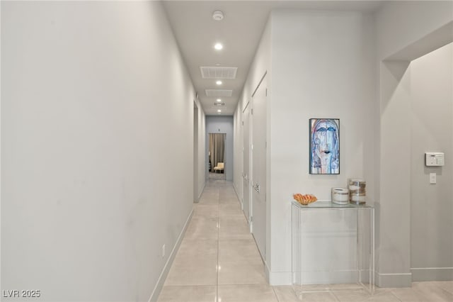 hall with light tile patterned floors