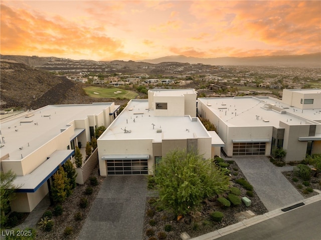 aerial view at dusk featuring a mountain view