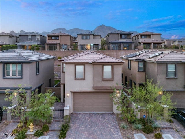 view of front of property with a mountain view and a garage