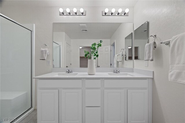 bathroom featuring vanity and a shower with shower door