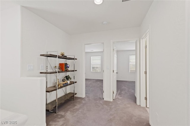 hallway with light colored carpet