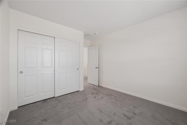 unfurnished bedroom with light carpet and a closet