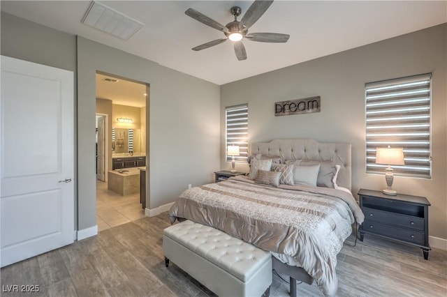 bedroom with ensuite bath, ceiling fan, and wood-type flooring