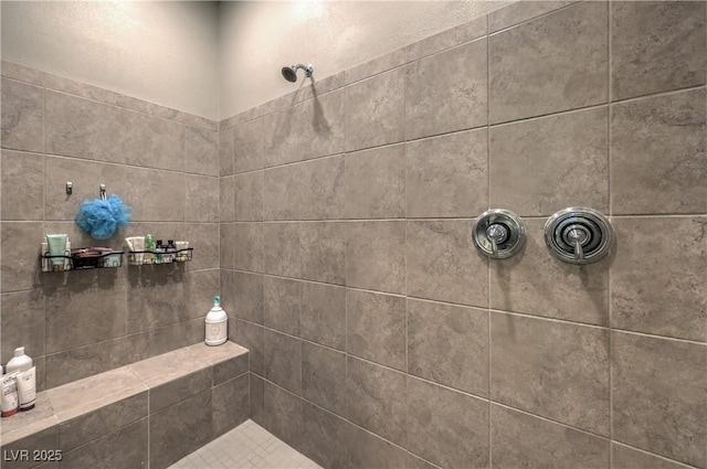 bathroom with tiled shower