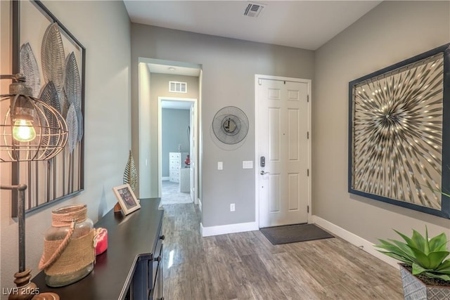 entryway with dark hardwood / wood-style flooring