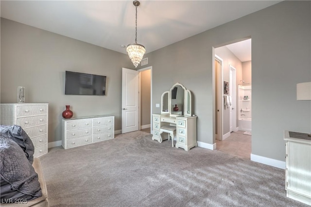 carpeted bedroom featuring ensuite bathroom and an inviting chandelier