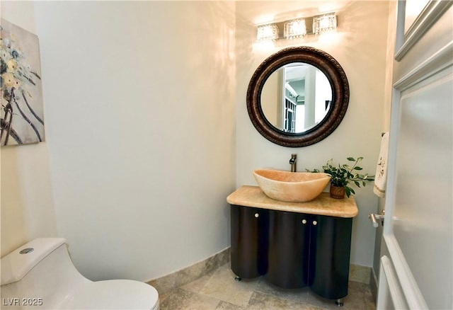 bathroom featuring vanity and toilet