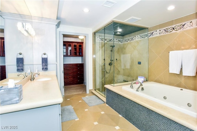 bathroom with tile patterned floors, vanity, and independent shower and bath