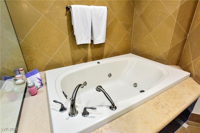 bathroom featuring a tub to relax in and tile walls