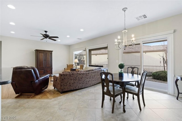 dining area with light tile patterned floors, ceiling fan with notable chandelier, visible vents, and recessed lighting