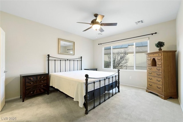 bedroom with visible vents, light carpet, baseboards, and a ceiling fan