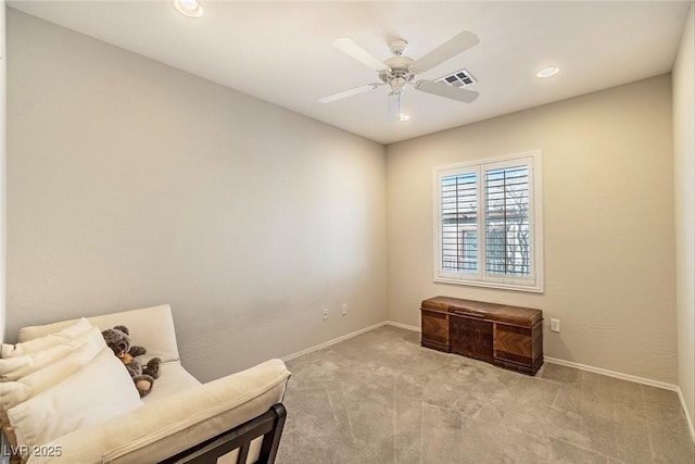 living area featuring a ceiling fan, light colored carpet, visible vents, and baseboards