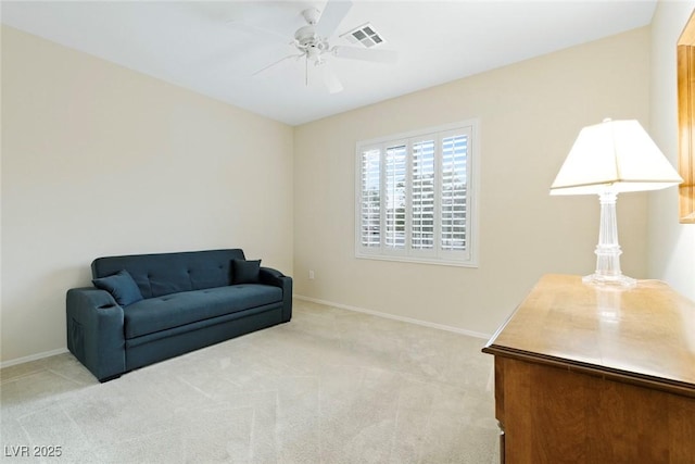 sitting room with a ceiling fan, visible vents, light colored carpet, and baseboards