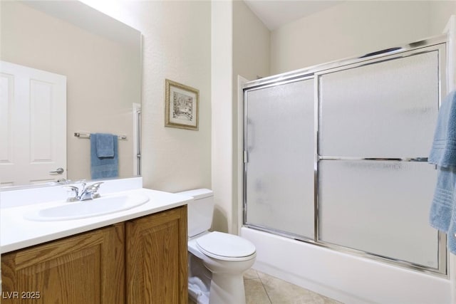 bathroom with shower / bath combination with glass door, toilet, vanity, and tile patterned flooring