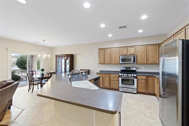 kitchen featuring dark countertops, visible vents, appliances with stainless steel finishes, and a sink