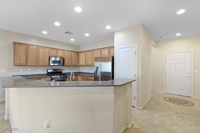 kitchen with dark countertops, recessed lighting, visible vents, and stainless steel appliances