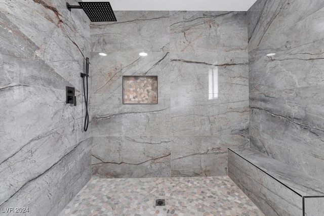 bathroom with a tile shower