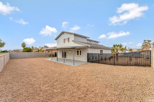 rear view of property featuring a patio