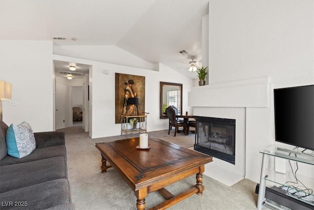 carpeted living room featuring ceiling fan, lofted ceiling, and a fireplace