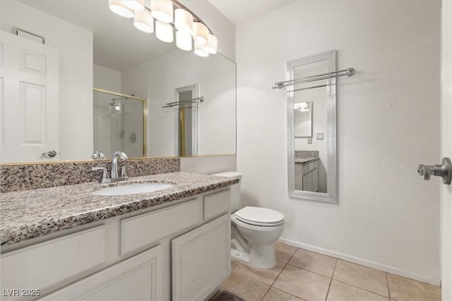 bathroom featuring tile patterned flooring, vanity, a shower with door, and toilet