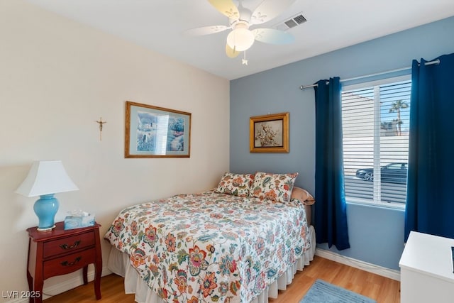 bedroom with ceiling fan and light hardwood / wood-style floors