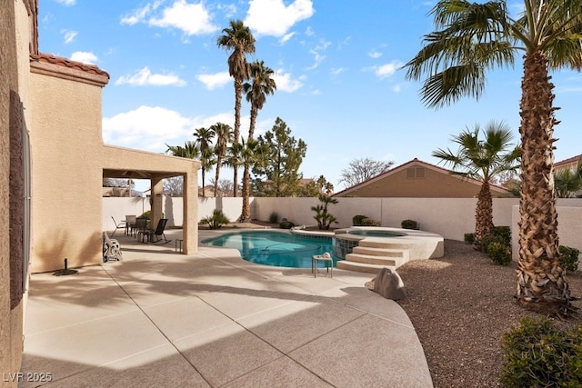 view of swimming pool featuring an in ground hot tub and a patio area