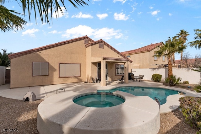 view of swimming pool with a patio area and an in ground hot tub