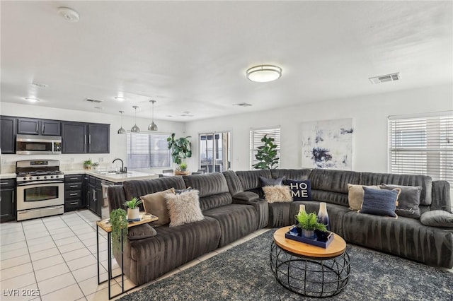 tiled living room with sink and a healthy amount of sunlight