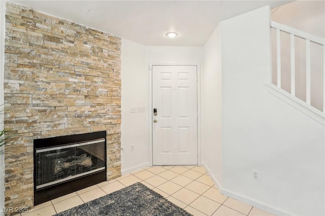 tiled foyer featuring a fireplace