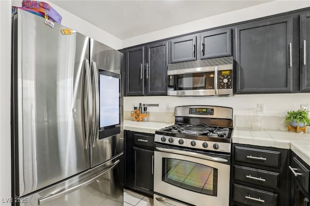 kitchen featuring appliances with stainless steel finishes and light tile patterned floors