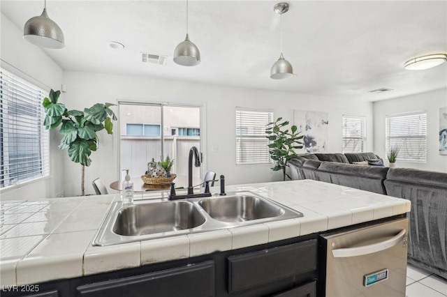 kitchen featuring decorative light fixtures, a wealth of natural light, and sink