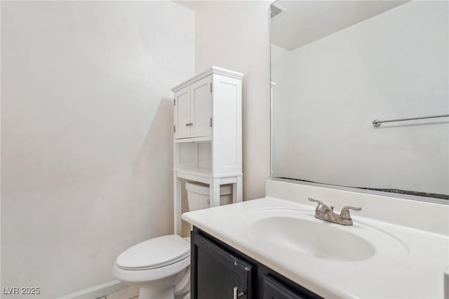 bathroom featuring vanity and toilet