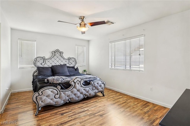 bedroom with ceiling fan and hardwood / wood-style floors