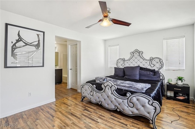 bedroom with hardwood / wood-style floors, ceiling fan, and ensuite bathroom